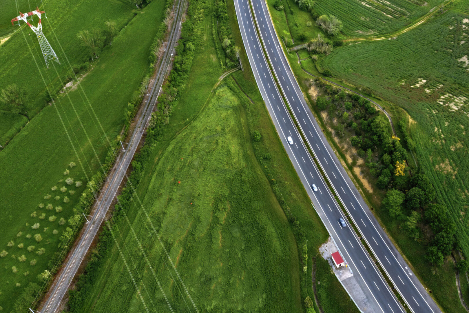 Aerial view of highway and green fields.